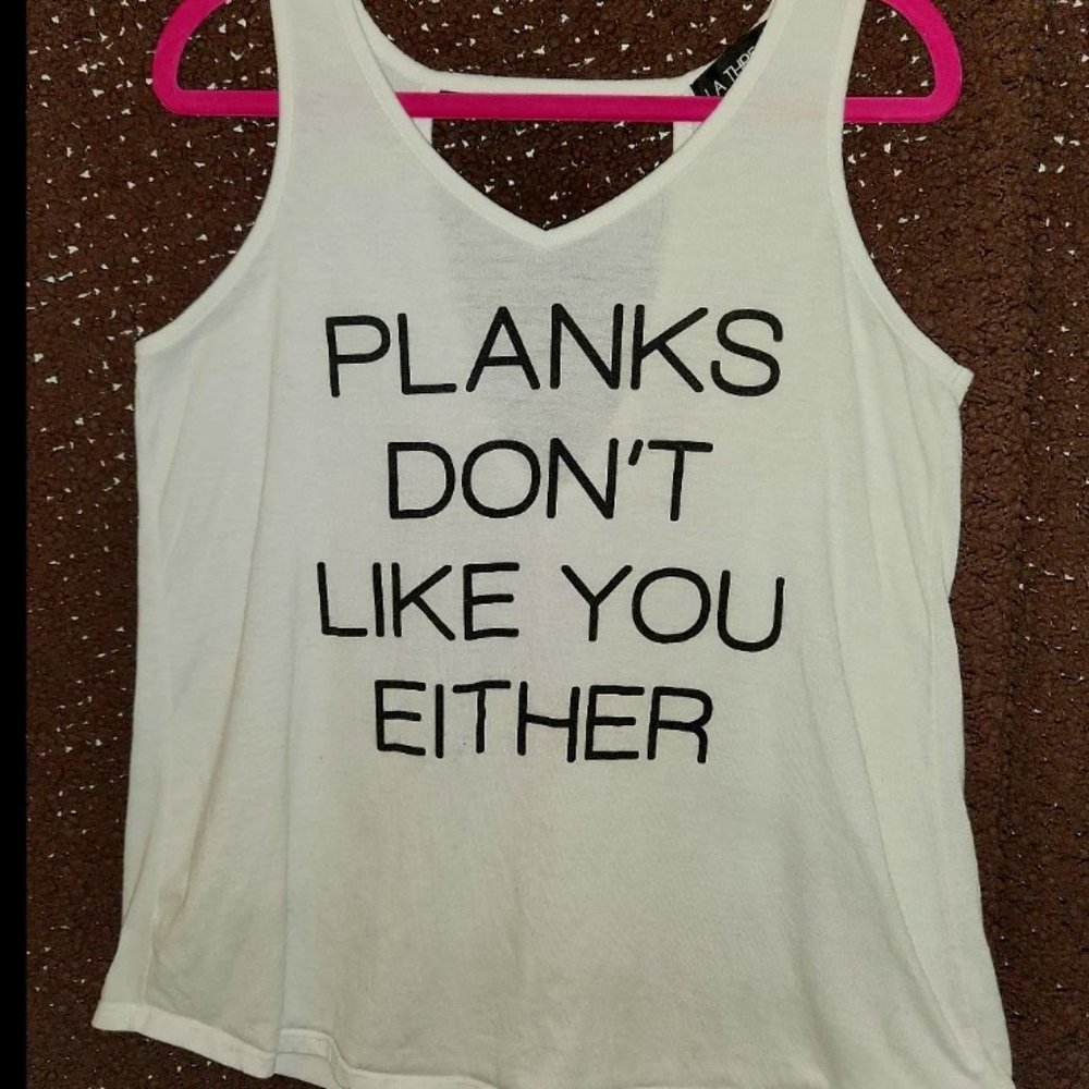 2 Tank Workout Shirts One is M and the other XL but they look the same size